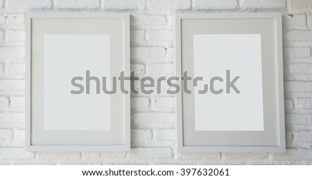 White empty frames on white wall.