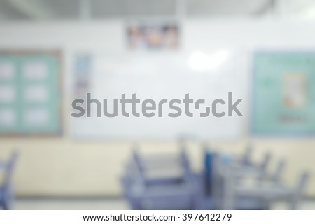 School classroom in blur background without young student; Blurry view of elementary class room no kid or teacher with chairs and tables in campus.