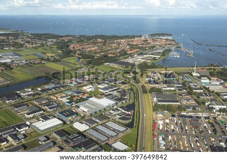 Aerial view of the ancient city of Enkhuizen, Netherlands. In the back of the picture lake IJsselmeer. In the front of the picture the business area's.