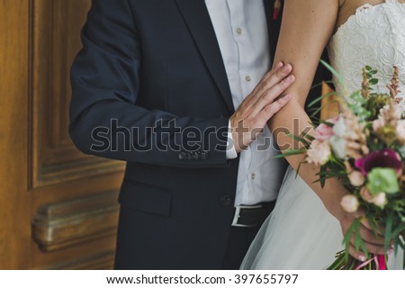 The bride is holding a bouquet of flowers.