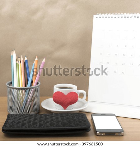 office desk : coffee with phone,wallet,calendar,heart,color pencil box on wood background