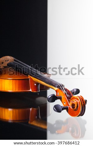 Old violin isolated on black and white background and glass desk