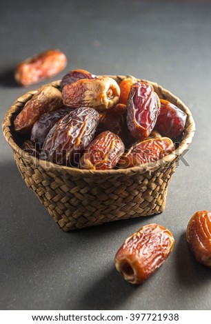Fine quality arabic dates arranged in an earthen bowl. Royalty-Free Stock Photo #397721938