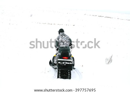 Man on snowmobile. Winter sports and entertainment.