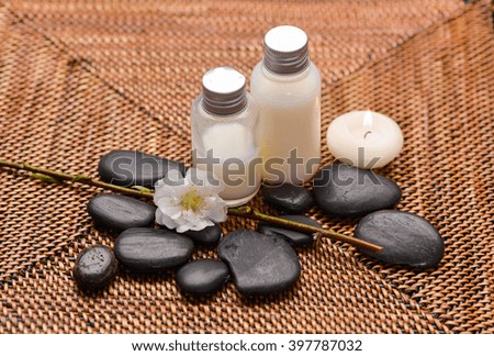 Spa set with black stones with candle ,flower oil on mat
