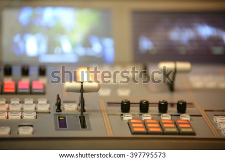 TV editor working with video and audio mixer