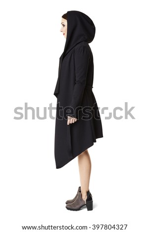 Side view of woman in black coat. Isolated on white background.