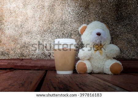 coffee cup,focused on teddy bear face in Blurred background with vintage filter