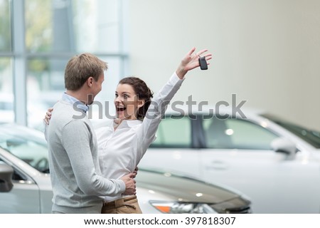 Embracing couple with car keys Royalty-Free Stock Photo #397818307