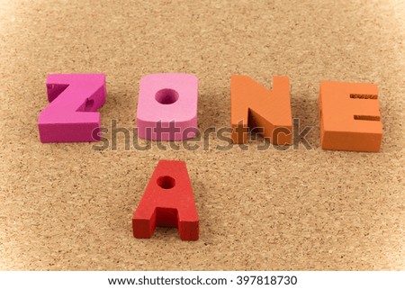 Colorful wooden English alphabets set sort zone A on brown cork wood  background