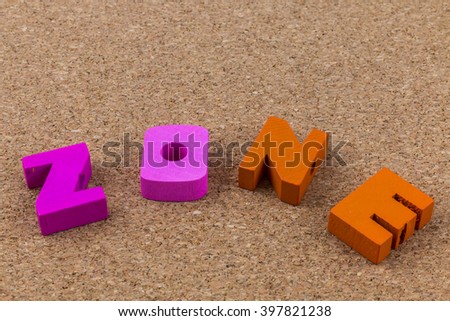 Colorful wooden English alphabets set on brown cork wood  background