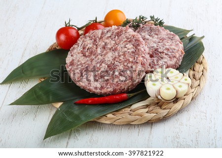 Raw beef merle burger cutlet on the bamboo leaves