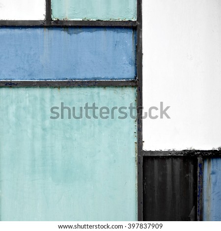 Geometric sheet metal door background with green, blue and grey colors, front view.