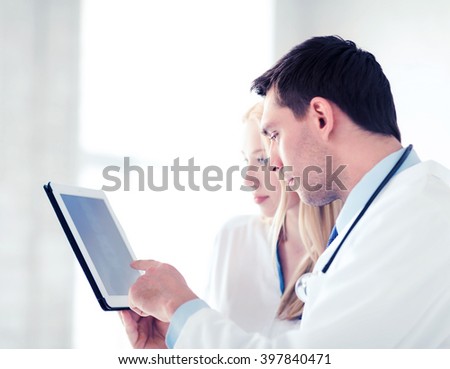 healthcare and medical - two doctors looking at x-ray on tablet pc
