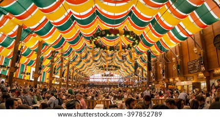 Munich, Germany- October 2, 2014:  People drinking in the Hippodrom Beer Tent on the Theresienwiese Oktoberfest fair grounds Royalty-Free Stock Photo #397852789