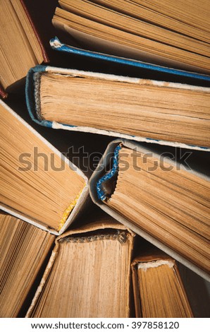 Old and used hardback books or text books seen from above.