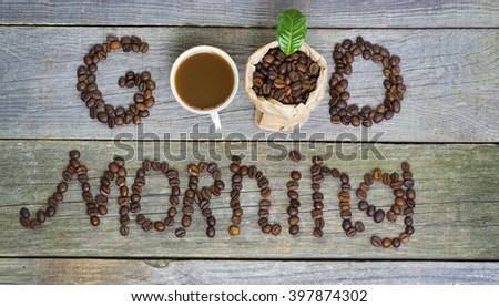 good morning concept - coffee beans, Cup of black coffee, heart from coffee beans, coffee leaves. Toned, selective focus image. lovely message
