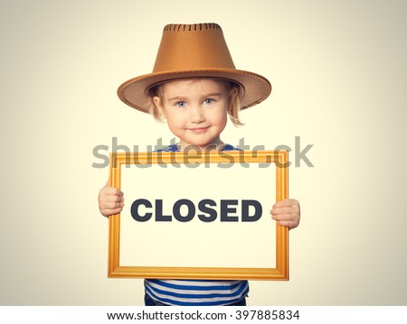 Little Funny girl in striped shirt with blackboard. Text CLOSED. Isolated on gray background.