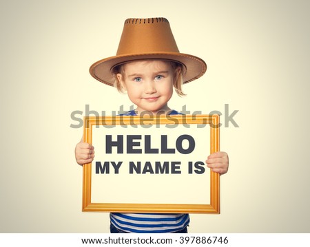 Little Funny girl in striped shirt with blackboard. Text HELLO MY NAME IS.  Isolated on gray background.