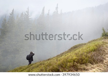 A man photographer shooting in Carpathian mountings