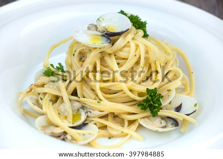 Spaghetti alla vongole on a wooden background 