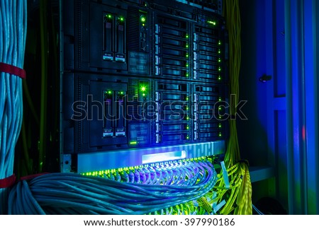 Network switch and UTP ethernet cables close-up in the server room Royalty-Free Stock Photo #397990186