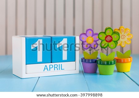 April 11th. Image of april 11 wooden color calendar on white background with flower. Spring day, empty space for text. International Day Of Fascist Concentration Camps Prisoners Liberation