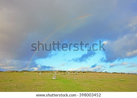 A partial rainbow over The Hurlers Bronze Age stone circle at Minions near Liskeard Cornwall England UK, It dates from about 1500 BC, towards the end of the early Bronze Age