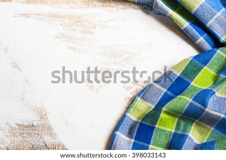 Kitchen towel or napkin  over the rustic wooden table. View from above with copy space
