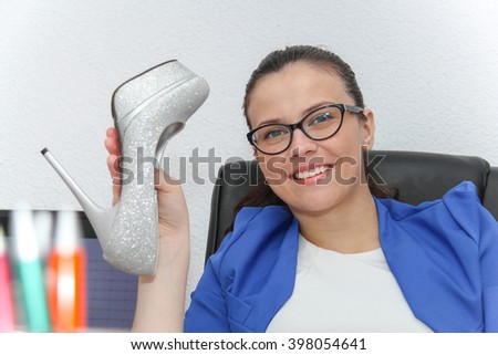 Photo of the Happy businesswoman sitting with her feet up in her office