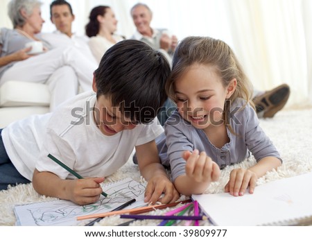 Children painting with their parents and grandparents in sofa at home