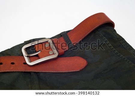Leather belt and Camouflage pants on white background