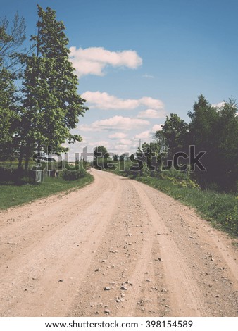 empty road in the countryside with trees in surrounding. perspective in autumn - vintage film effect