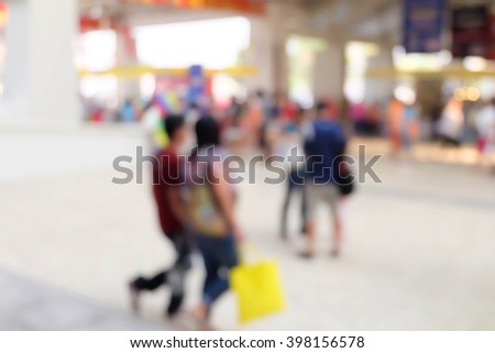 Blurred image of people in shopping mall with blur background.