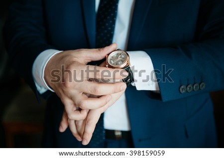 businessman looking at his watch on his hand, watching the time Royalty-Free Stock Photo #398159059