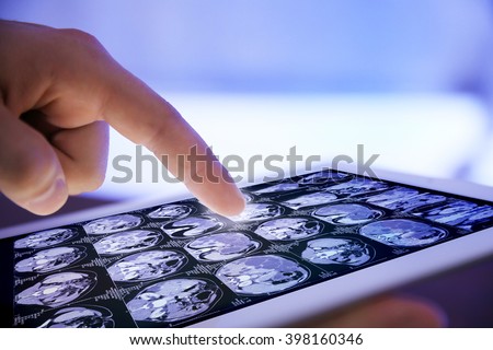 Doctor hand touching modern digital tablet, close up Royalty-Free Stock Photo #398160346