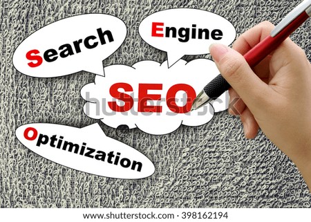 hand holding pen on search engine optimization tag with on surface of towel