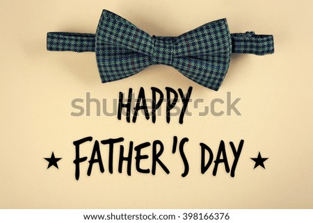 Happy Father's Day. Male bow tie on beige background
