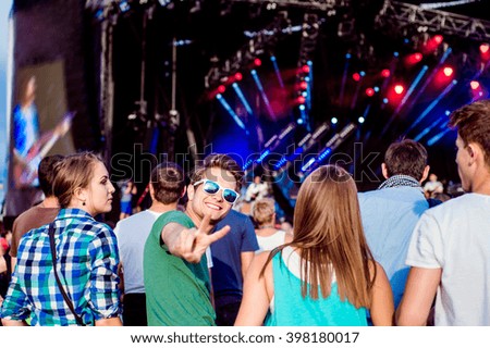 Teenagers at summer music festival having fun