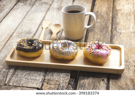 Donuts, black coffee on the wooden table
