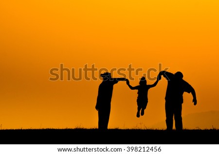 silhouette family over grass background at sunset