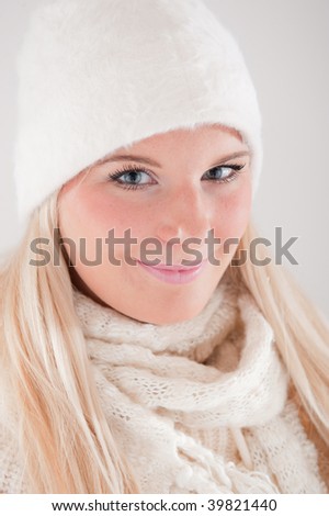 Young beautiful winter girl in knit hat and scarf
