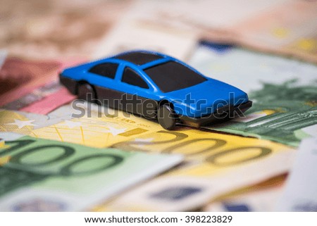 blue Toy car and euro