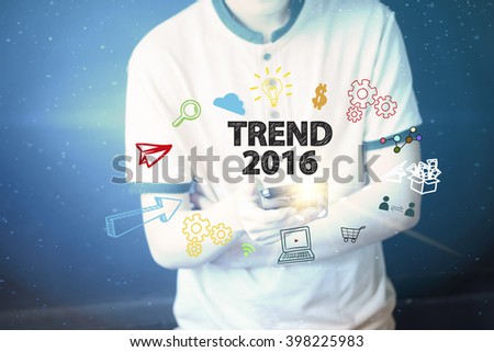 Young man holding a smart phone  with TREND 2016 text ,business concept