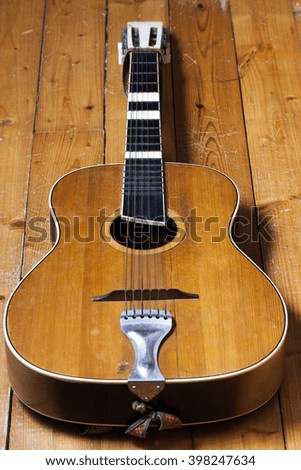 Acoustic guitar on wooden background 