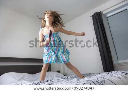 A girl singer having fun in the bedroom