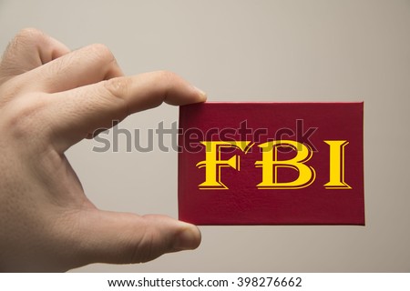 FBI Special Agent, certificate with red cover for identification. Man's hand hold document