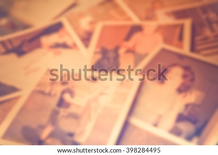 Defocused blur of scattered old family photographs 