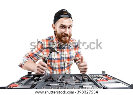 the young bearded man hold a repair tools