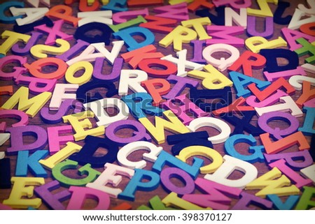 Random Abstract Pattern From English Wooden Colorful Letters On the Brown Wood Background, Close Up, Top View, Horizontal Image, Copy Space
